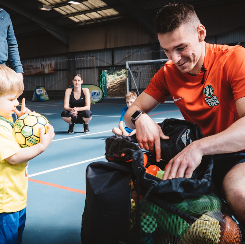 Coach with child and bag of equipment